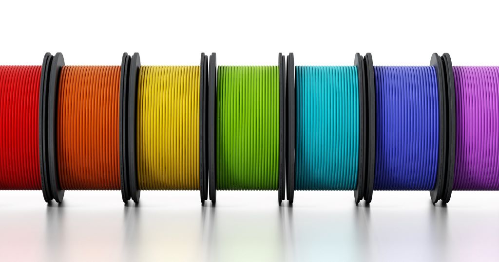 Various 3D printing filaments in different colors and materials arranged for comparison