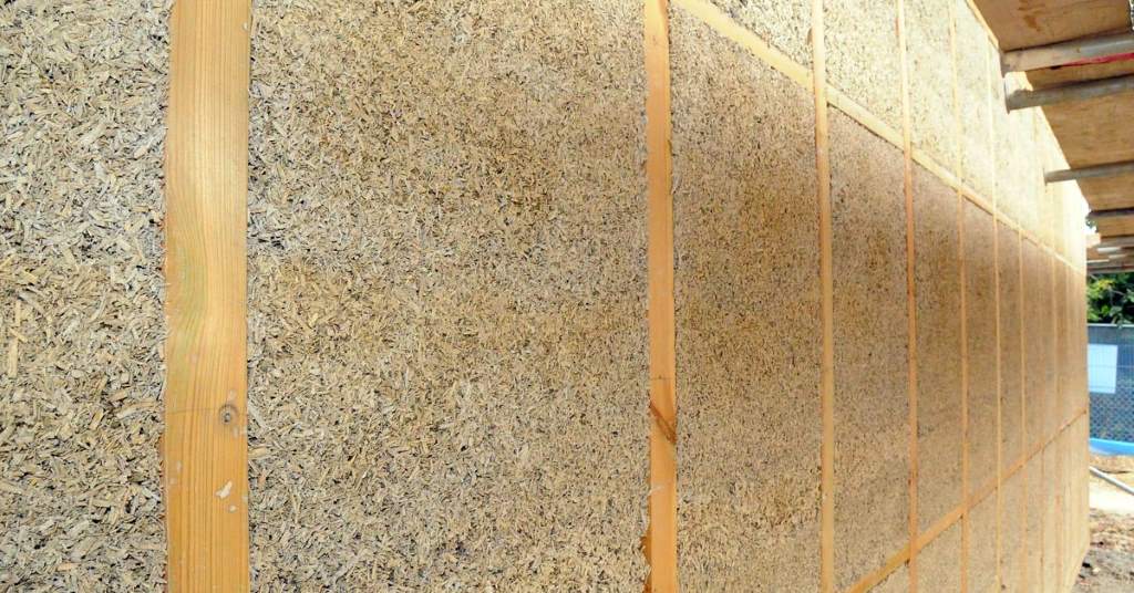 hempcrete wall assembly showing hemp hurd and lime binder texture in a sustainable home addition
