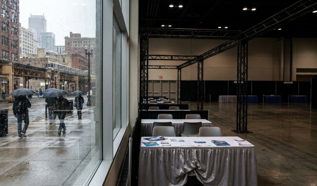Prospective international students exploring academic booth displays in an exhibition hall